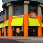 Outside restaurant with yellow awnings.