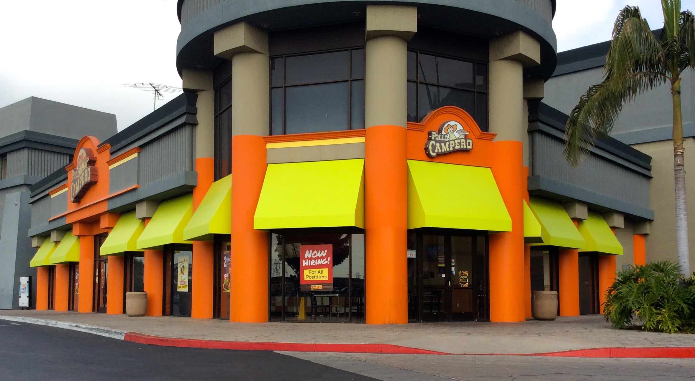 Outside restaurant with yellow awnings.