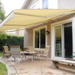 Motorized patio awnings over a backyard