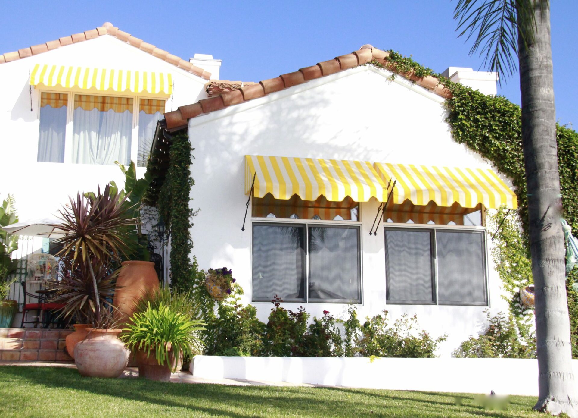 Home with yellow striped spear awnings